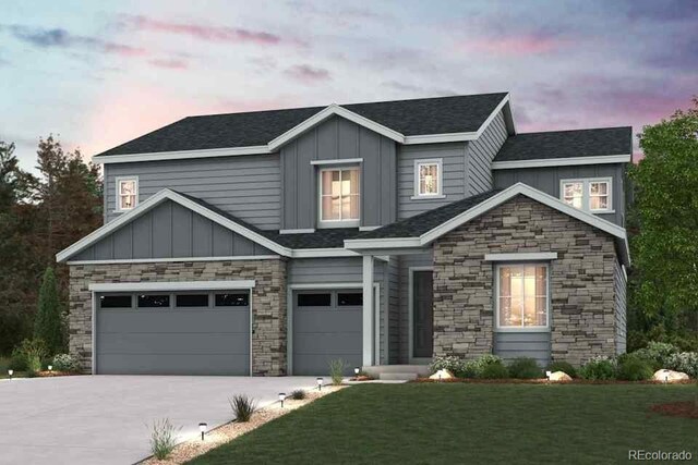 2465 Lupton Ln, Lafayette, CO 80026 - view of front of house with stone siding, board and batten siding, driveway, a yard, and an attached garage