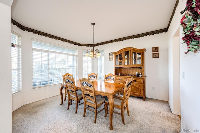 dining area featuring a notable chandelier and light colored carpet