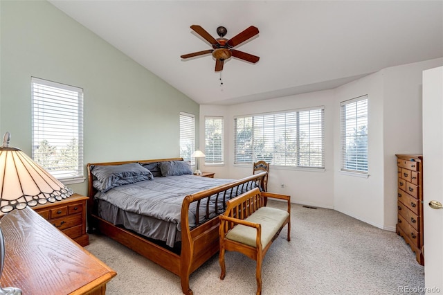 bedroom with vaulted ceiling, light colored carpet, and ceiling fan