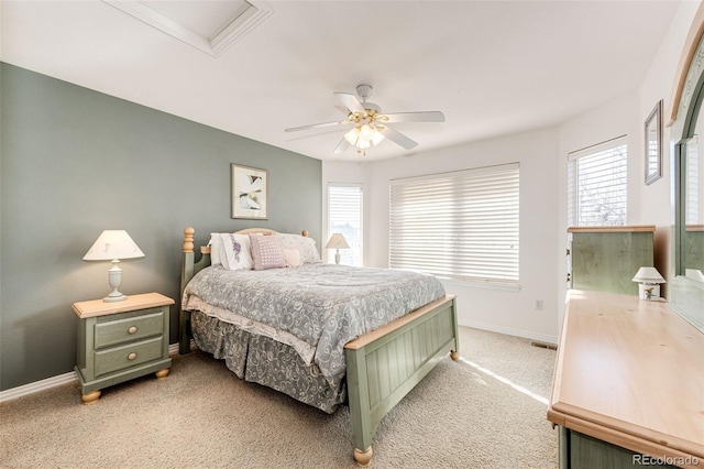 bedroom with multiple windows, light carpet, and ceiling fan