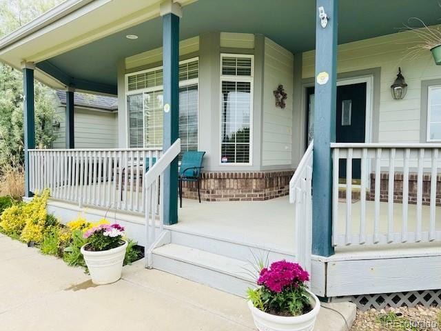 935 Green Gables Cir, Bennett, CO 80102 - doorway to property with a porch and brick siding