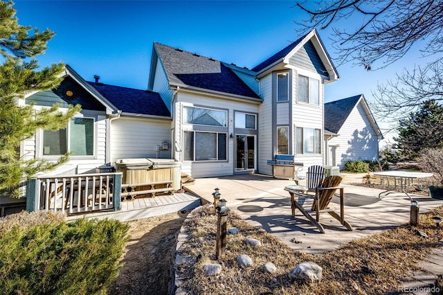 935 Green Gables Cir, Bennett, CO 80102 - rear view of house with a hot tub, a patio area, and a shingled roof