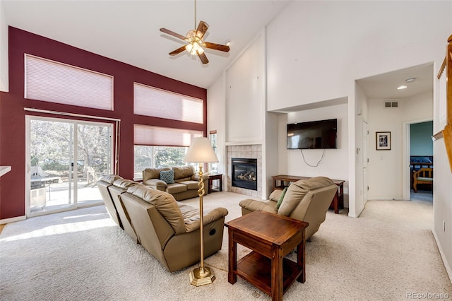 935 Green Gables Cir, Bennett, CO 80102 - living area featuring high vaulted ceiling, light colored carpet, a ceiling fan, and a fireplace