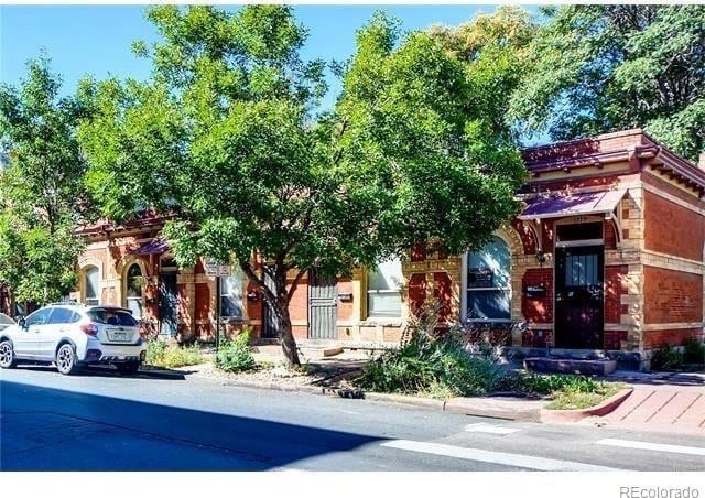 1767 N Washington St, Denver, CO 80203 - view of property hidden behind natural elements with brick siding