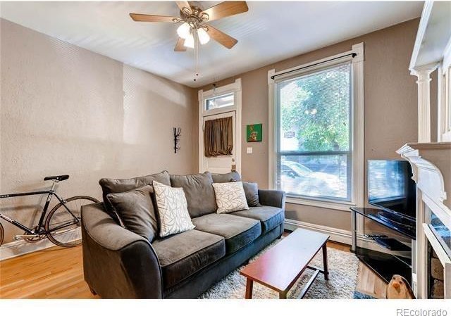 1767 N Washington St, Denver, CO 80203 - living area with wood finished floors, a ceiling fan, and baseboards