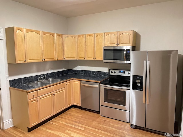 1767 N Washington St, Denver, CO 80203 - kitchen with appliances with stainless steel finishes, light brown cabinetry, a sink, light wood-type flooring, and tile counters