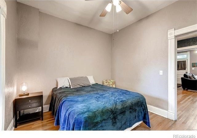 1767 N Washington St, Denver, CO 80203 - bedroom with wood finished floors, baseboards, and a ceiling fan