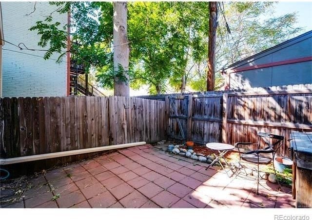 1767 N Washington St, Denver, CO 80203 - fenced backyard with a patio area