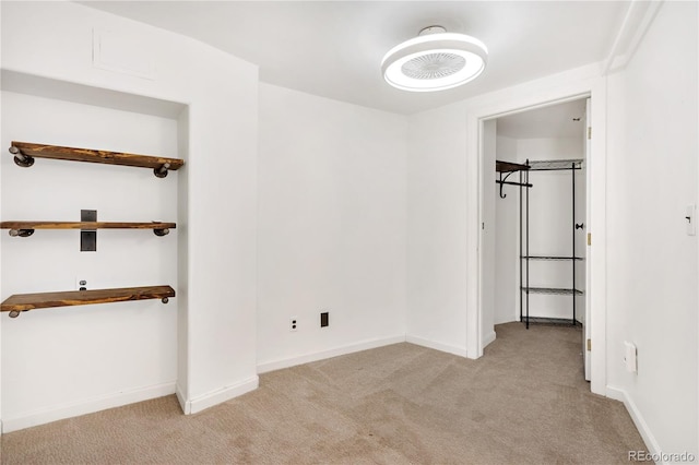 unfurnished bedroom featuring light carpet