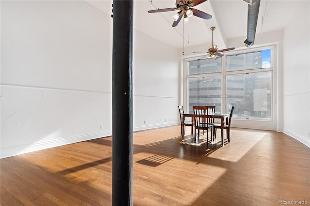 dining space with wood-type flooring and ceiling fan