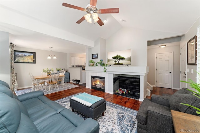 1385 W 112th Ave Unit D, Denver, CO 80234 - living area featuring ceiling fan, a tile fireplace, baseboards, wood finished floors, and high vaulted ceiling