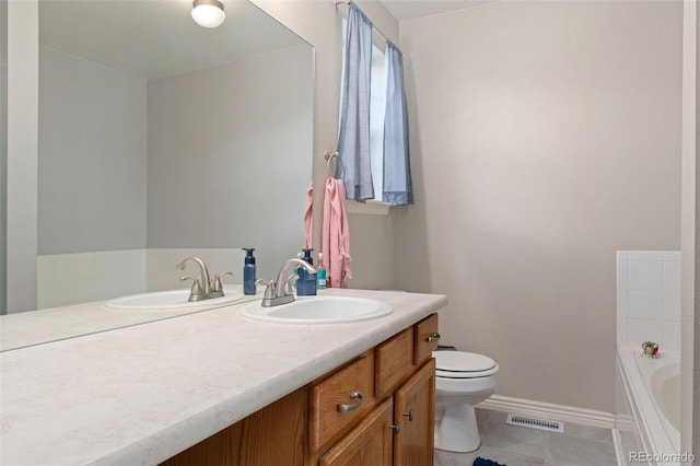 1385 W 112th Ave Unit D, Denver, CO 80234 - bathroom with toilet, vanity, a tub, baseboards, and tile patterned flooring