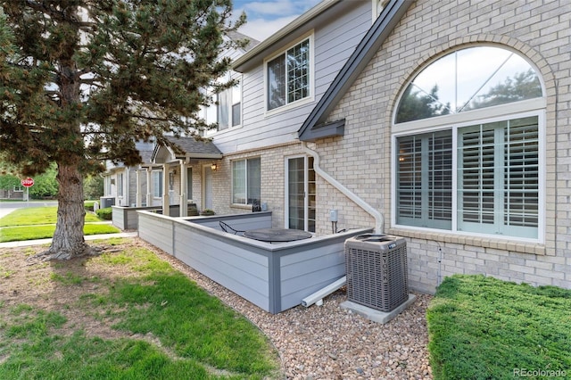 1385 W 112th Ave Unit D, Denver, CO 80234 - back of house featuring central AC unit and brick siding