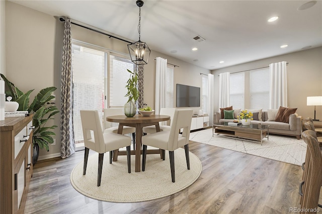3386 Valentia St, Denver, CO 80238 - dining area with plenty of natural light, wood finished floors, recessed lighting, baseboards, and a chandelier
