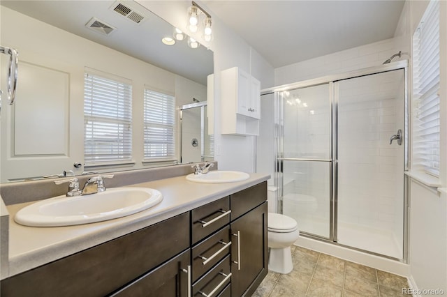 3386 Valentia St, Denver, CO 80238 - bathroom with a stall shower, toilet, plenty of natural light, and double vanity