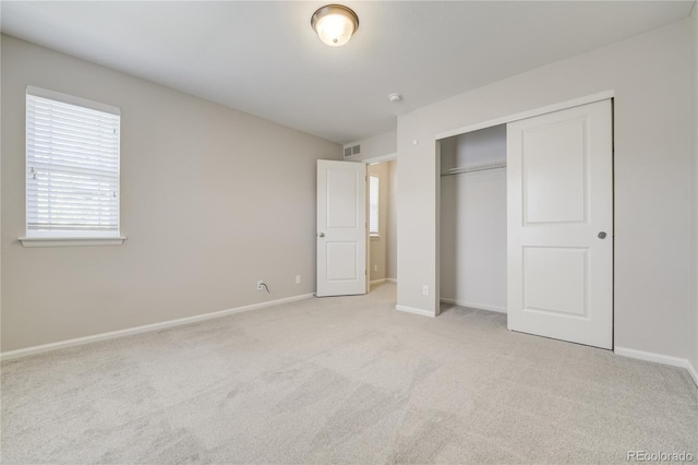 3386 Valentia St, Denver, CO 80238 - unfurnished bedroom featuring light colored carpet, baseboards, and a closet