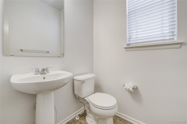 3386 Valentia St, Denver, CO 80238 - bathroom with baseboards, toilet, a sink, and tile patterned flooring