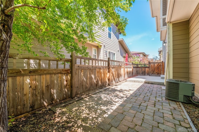 3386 Valentia St, Denver, CO 80238 - view of patio / terrace featuring central air condition unit and a fenced backyard