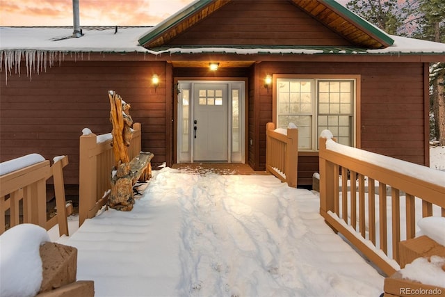 view of snow covered property entrance