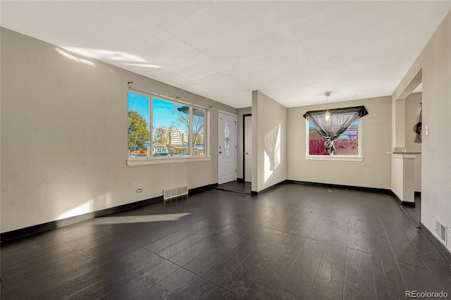 empty room featuring dark hardwood / wood-style flooring