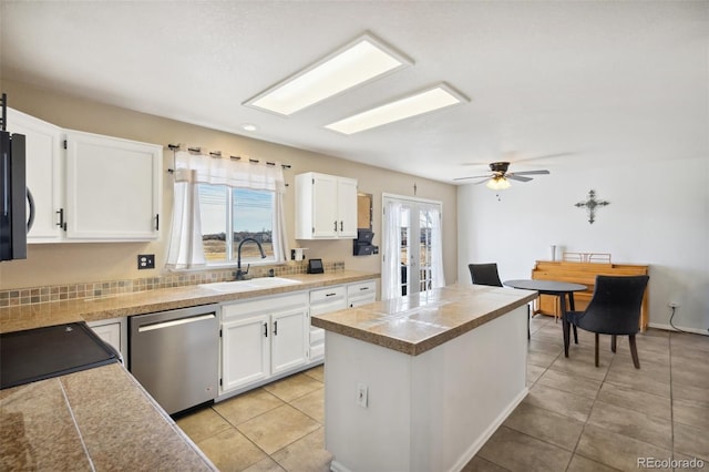 kitchen with dishwasher, tile countertops, a healthy amount of sunlight, and a sink