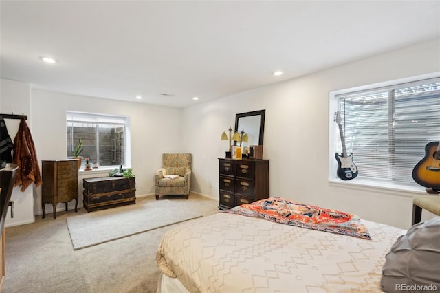 carpeted bedroom featuring recessed lighting, baseboards, and multiple windows