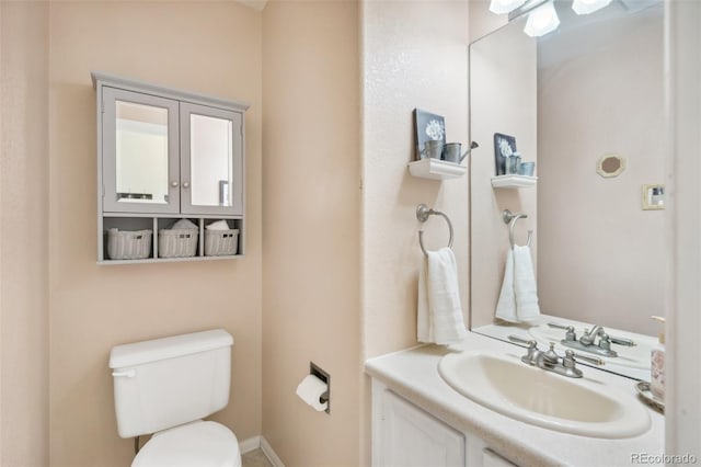 half bathroom featuring toilet and vanity