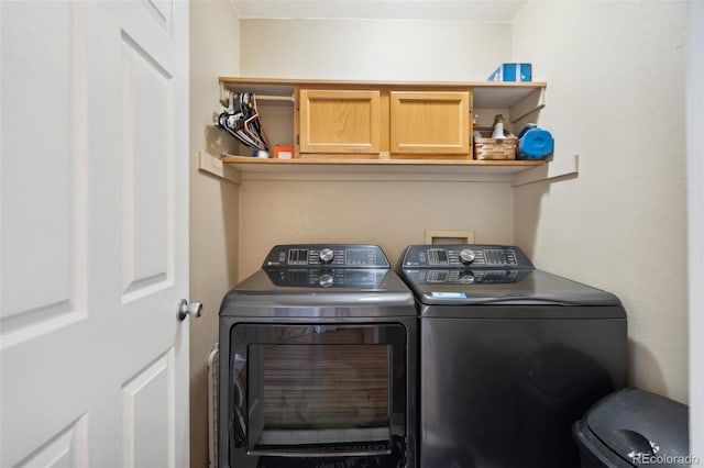 laundry area with cabinet space and washing machine and dryer