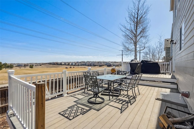 wooden terrace featuring outdoor dining space