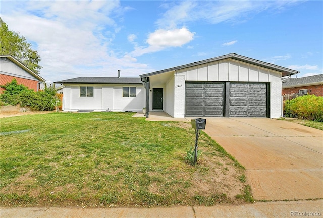 single story home featuring a garage, a front lawn, brick siding, board and batten siding, and driveway