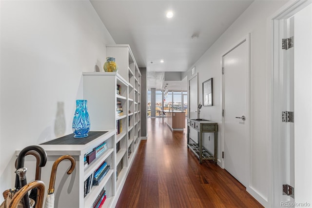 hall featuring recessed lighting and dark wood-type flooring