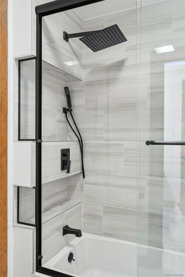 bathroom featuring shower / bath combination with glass door