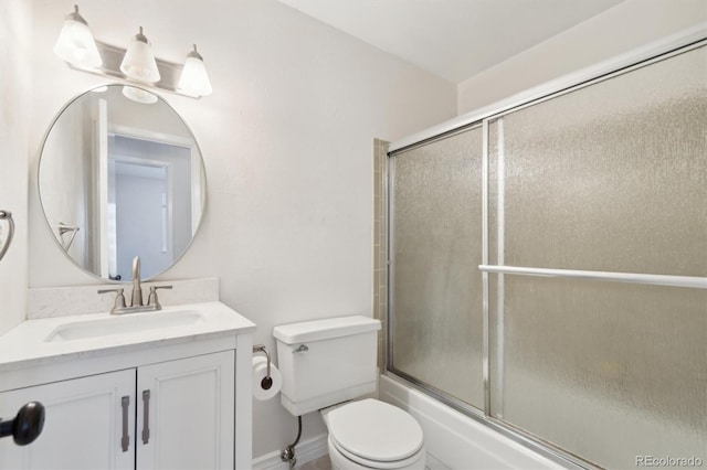 full bathroom featuring bath / shower combo with glass door, toilet, and vanity