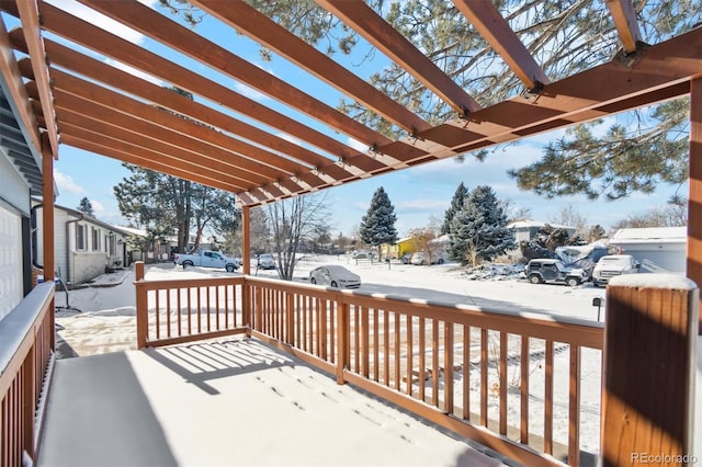 snow covered deck featuring a pergola