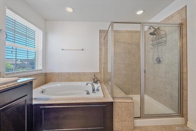 bathroom featuring vanity and plus walk in shower