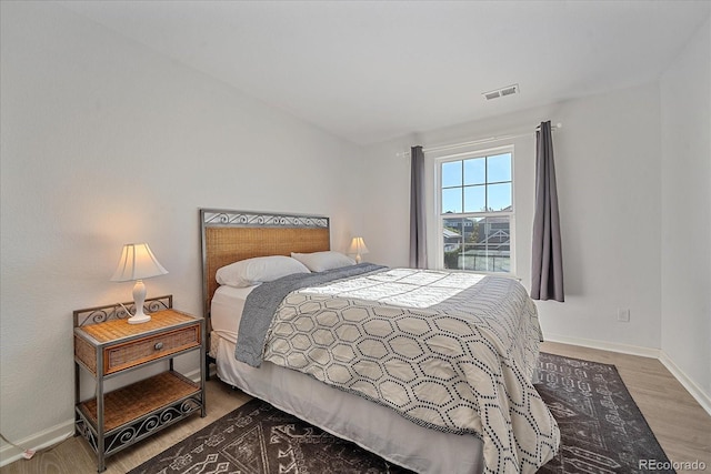 bedroom with wood-type flooring