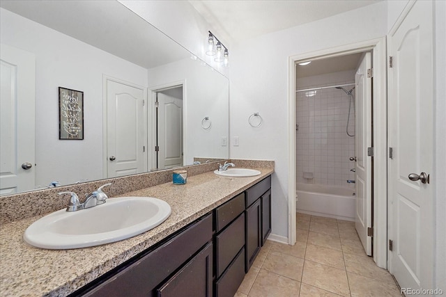 bathroom featuring tiled shower / bath combo, tile patterned floors, and vanity