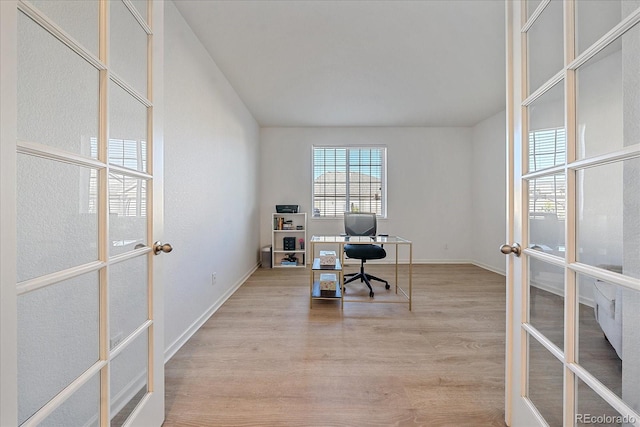 office area with light hardwood / wood-style flooring and french doors