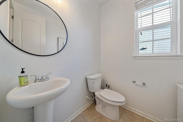 bathroom with toilet and tile patterned floors