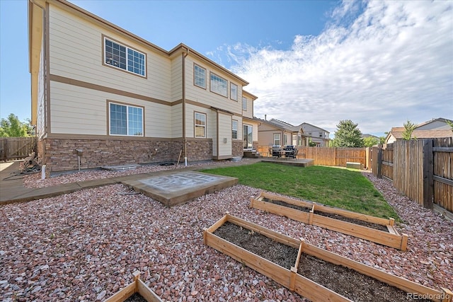 back of property featuring a patio area and a yard