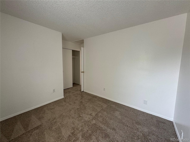 carpeted spare room with a textured ceiling