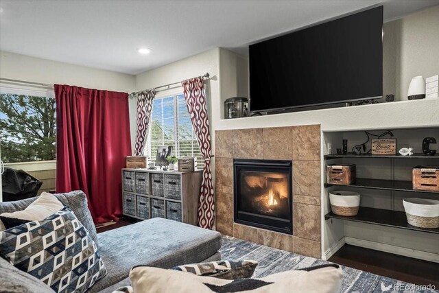 15800 E 121st Ave Unit 4K, Brighton, CO 80603 - living area featuring a tiled fireplace, wood finished floors, and recessed lighting