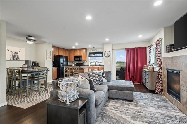 15800 E 121st Ave Unit 4K, Brighton, CO 80603 - living room with a tile fireplace, dark wood-type flooring, recessed lighting, and a ceiling fan