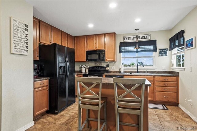 15800 E 121st Ave Unit 4K, Brighton, CO 80603 - kitchen featuring black appliances, a sink, dark countertops, plenty of natural light, and recessed lighting