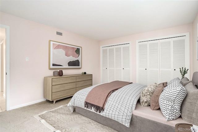 carpeted bedroom with multiple closets