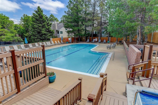 pool featuring a patio and fence