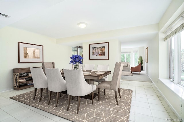 tiled dining room with visible vents and baseboards