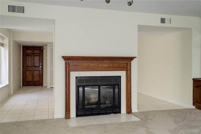 room details featuring carpet floors, visible vents, and a glass covered fireplace