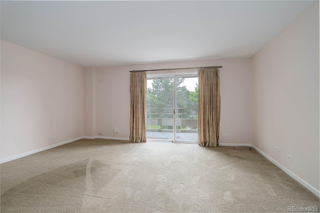 empty room with carpet and baseboards