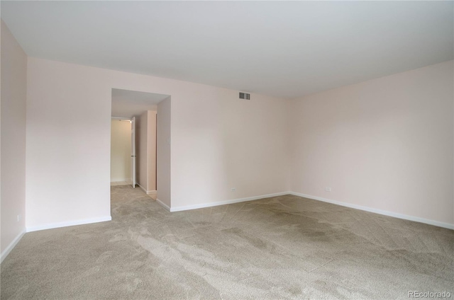 unfurnished room featuring baseboards, visible vents, and carpet flooring